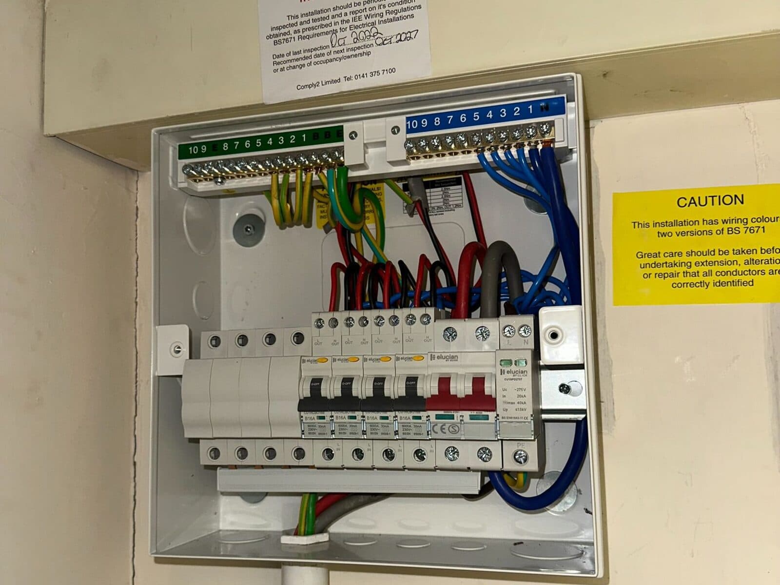 New consumer unit with the cover open, showing neat wiring and labelled breakers